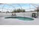 Kidney shaped pool with screened enclosure at 7664 39Th Street E Cir, Sarasota, FL 34243