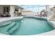 Inviting kidney shaped pool with a screened enclosure at 7664 39Th Street E Cir, Sarasota, FL 34243