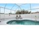 Relaxing pool with screened enclosure and lounge chairs at 7664 39Th Street E Cir, Sarasota, FL 34243