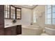 Bathroom with corner tub, double vanity, and dark wood cabinets at 777 N Manasota Key Rd, Englewood, FL 34223