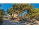 Palm-tree-lined driveway leading to beachfront home at 777 N Manasota Key Rd, Englewood, FL 34223