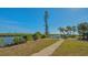 Brick pathway leads to waterfront, lush landscaping at 777 N Manasota Key Rd, Englewood, FL 34223