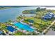 Aerial view of community pool, clubhouse, and lake at 8043 Waterbend Trl, Sarasota, FL 34240