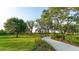 Landscaped walking path winds through lush green space at 8043 Waterbend Trl, Sarasota, FL 34240