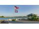 Relaxing waterfront patio with seating and American flag at 8043 Waterbend Trl, Sarasota, FL 34240