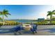 Fire pit with blue Adirondack chairs and lake view at 8043 Waterbend Trl, Sarasota, FL 34240