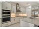 Modern kitchen with stainless steel appliances and white cabinets at 8043 Waterbend Trl, Sarasota, FL 34240