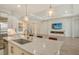 Kitchen island with sink and view to living room at 8043 Waterbend Trl, Sarasota, FL 34240