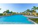 Expansive resort-style pool with cabanas and lounge chairs at 8043 Waterbend Trl, Sarasota, FL 34240