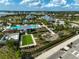 An aerial view of community amenities including a pool, playground, bocce ball court, and pristine landscaping at 8261 Grande Shores Dr, Sarasota, FL 34240