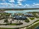 Stunning aerial view of community clubhouse, pool and lake, perfect for relaxation and recreation at 8261 Grande Shores Dr, Sarasota, FL 34240