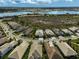 An aerial view showcasing homes in a well-planned community with a large lake in the background at 8261 Grande Shores Dr, Sarasota, FL 34240