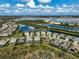 Stunning aerial view showcases the home's location near serene waterways and lush, green surroundings at 8261 Grande Shores Dr, Sarasota, FL 34240