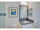 Bathroom vanity with granite countertop, decorative mirror, and stylish mosaic tile accents at 8261 Grande Shores Dr, Sarasota, FL 34240