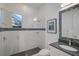 Contemporary bathroom featuring a glass-enclosed shower, white tile, modern fixtures, and a stylish vanity at 8261 Grande Shores Dr, Sarasota, FL 34240