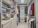 Well-organized walk-in closet with custom shelving, drawers, and ample storage space at 8261 Grande Shores Dr, Sarasota, FL 34240