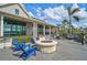 Clubhouse patio featuring fire pit, seating, and views of the surrounding landscape at 8261 Grande Shores Dr, Sarasota, FL 34240