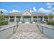 Exterior of the clubhouse with an outdoor firepit, seating area, and a well-maintained facade at 8261 Grande Shores Dr, Sarasota, FL 34240