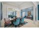 Elegant dining room featuring modern lighting, stylish chairs, and a large mirror at 8261 Grande Shores Dr, Sarasota, FL 34240