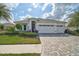 Charming single-story home featuring a three-car garage and meticulously maintained front yard at 8261 Grande Shores Dr, Sarasota, FL 34240