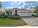 Well-maintained single-story home boasting a three-car garage and professionally landscaped front yard at 8261 Grande Shores Dr, Sarasota, FL 34240