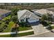 Beautiful single-story home featuring a three-car garage, lush landscaping and a tile roof at 8261 Grande Shores Dr, Sarasota, FL 34240