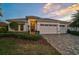 Charming single-story home boasting a three-car garage and meticulously landscaped front yard at 8261 Grande Shores Dr, Sarasota, FL 34240