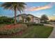 Striking single-story home showcasing lush landscaping, a three-car garage, and inviting curb appeal at 8261 Grande Shores Dr, Sarasota, FL 34240