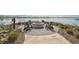 Outdoor fire pit area with comfortable seating overlooking a serene lake at 8261 Grande Shores Dr, Sarasota, FL 34240