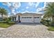 Charming single-story home boasts a meticulously landscaped yard and a welcoming three-car garage at 8261 Grande Shores Dr, Sarasota, FL 34240