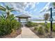 Picturesque kayak rinsing station on the lake with lush landscaping, a covered structure, and informational signage at 8261 Grande Shores Dr, Sarasota, FL 34240