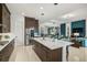 Modern kitchen with stainless steel appliances, center island, and custom cabinetry at 8261 Grande Shores Dr, Sarasota, FL 34240