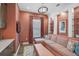 Cozy living room featuring patterned wallpaper, a comfortable sectional sofa, built-in shelving, and stylish decor at 8261 Grande Shores Dr, Sarasota, FL 34240