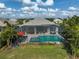 Aerial view of a screened pool and hot tub, perfect for outdoor entertaining and relaxation at 8261 Grande Shores Dr, Sarasota, FL 34240