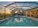 Inviting screened pool with a spa and sun loungers, perfect for relaxing and enjoying the sunset at 8261 Grande Shores Dr, Sarasota, FL 34240