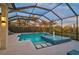 Beautiful screened in pool with spa and fountain in an outdoor oasis at 8261 Grande Shores Dr, Sarasota, FL 34240