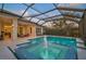 A screened pool and spa with a water feature is the center of a large outdoor space at 8261 Grande Shores Dr, Sarasota, FL 34240