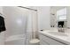 Clean bathroom with a white vanity, tub, and shower at 8612 Evening Dr, Sarasota, FL 34241