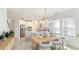 Bright dining area with a long wooden table and white chairs at 8612 Evening Dr, Sarasota, FL 34241