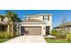 Two-story house with a brown garage door and landscaped yard at 8612 Evening Dr, Sarasota, FL 34241