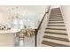 Modern kitchen with island, white cabinets, and staircase at 8612 Evening Dr, Sarasota, FL 34241