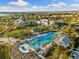 Community aerial view showing a resort-style pool, clubhouse, and lush landscaping at 883 Seascape Pl, Sarasota, FL 34240