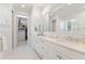 Elegant bathroom with double vanity, large mirror, and walk-in closet at 883 Seascape Pl, Sarasota, FL 34240