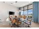 Bright community room features a large table, comfortable seating, and water views at 883 Seascape Pl, Sarasota, FL 34240