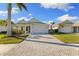 Charming single-story house with a two-car garage and a neatly landscaped yard at 883 Seascape Pl, Sarasota, FL 34240