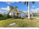 Charming single-story home with a landscaped yard and palm trees at 883 Seascape Pl, Sarasota, FL 34240