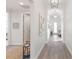 Bright and airy hallway with light walls and wood-look flooring at 883 Seascape Pl, Sarasota, FL 34240