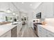 Open concept kitchen with white cabinets and a large island at 883 Seascape Pl, Sarasota, FL 34240