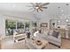 Bright living room with comfy sofas, coffee table, and view of the pool at 883 Seascape Pl, Sarasota, FL 34240