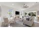 Open living room and dining area with sliding doors to pool area at 883 Seascape Pl, Sarasota, FL 34240